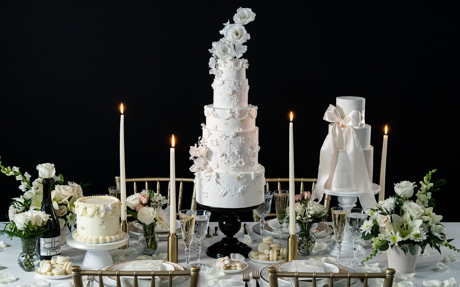 elegant black and white wedding cakes with flowers roses peonies and macarons