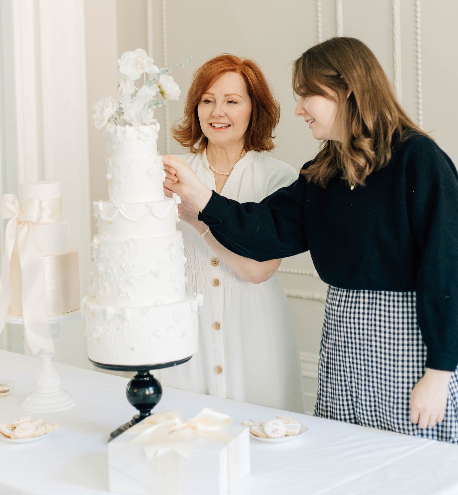 Amanda and Maddy decorating a wedding cake