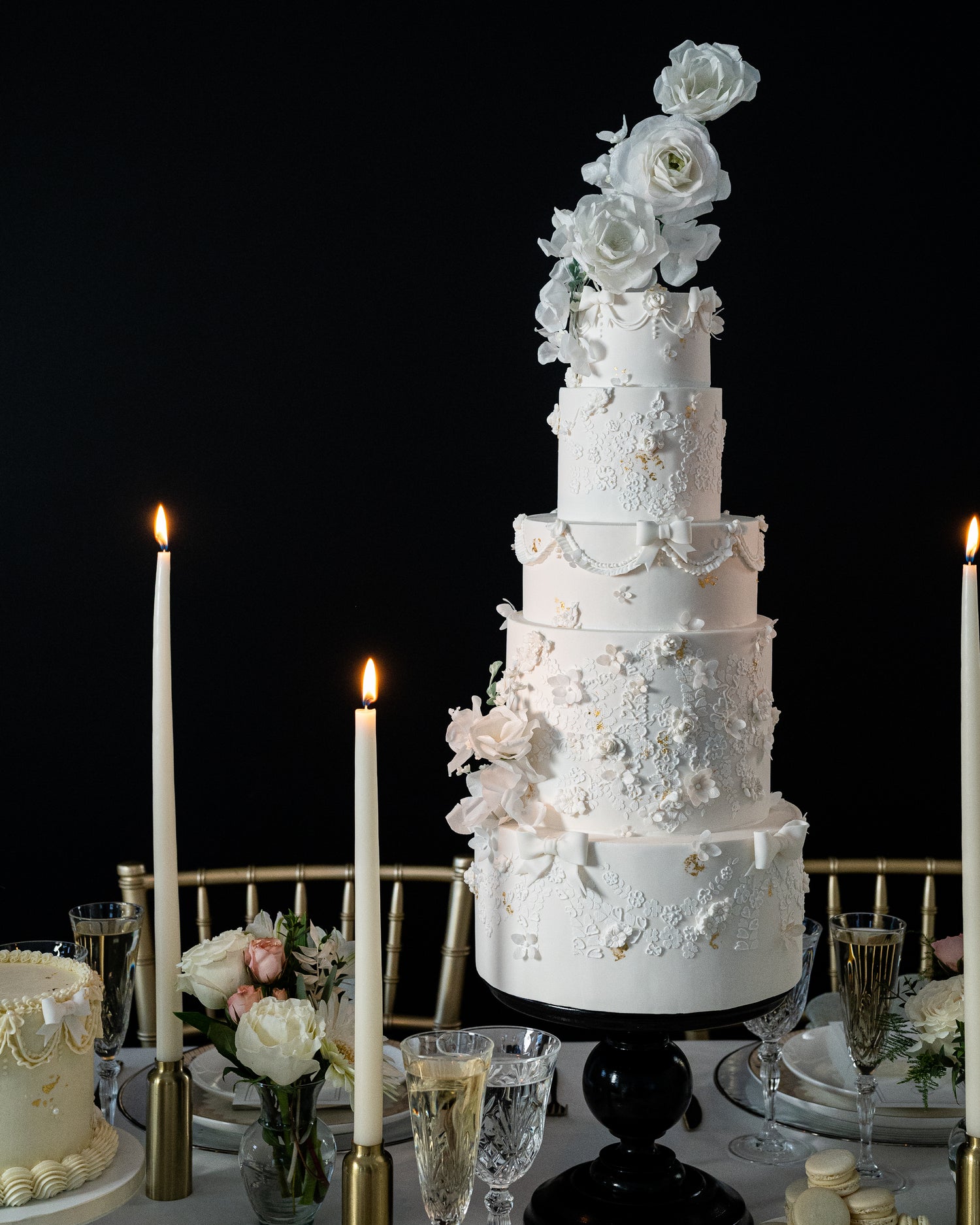tall white wedding cake by sugar nursery in halifax, nova scotia, inspired by bridal dresses decorated with sugar flowers and lace