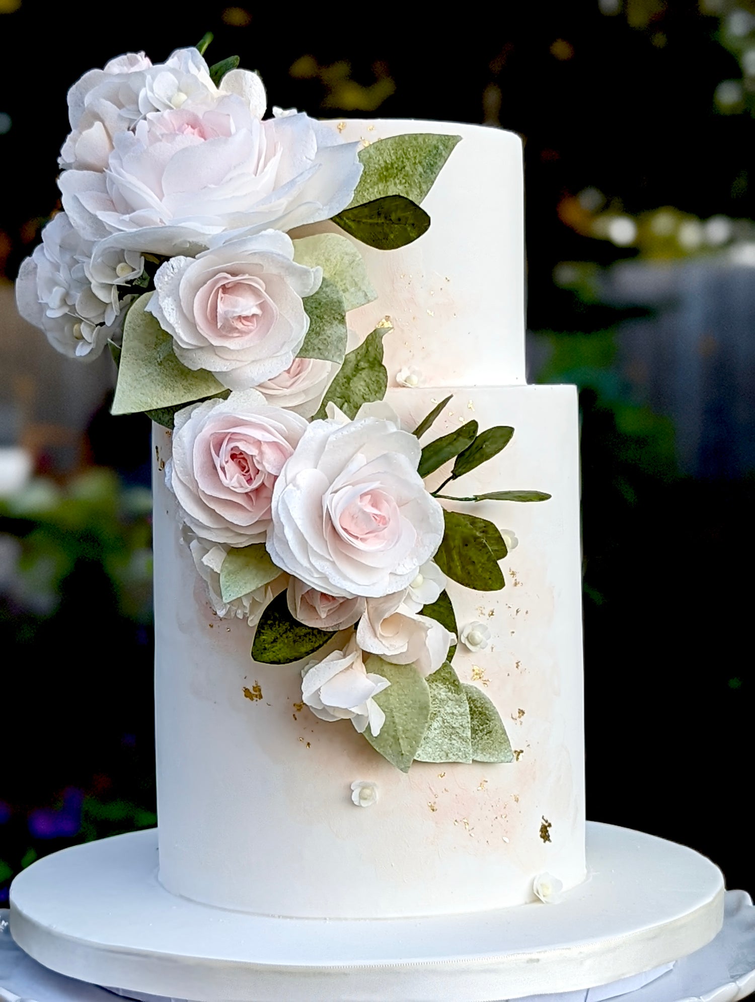 elegant floral wedding cake made by sugar nursery in halifax nova scotia with blush, green, and cream roses and peonies, and painted watercolour finish